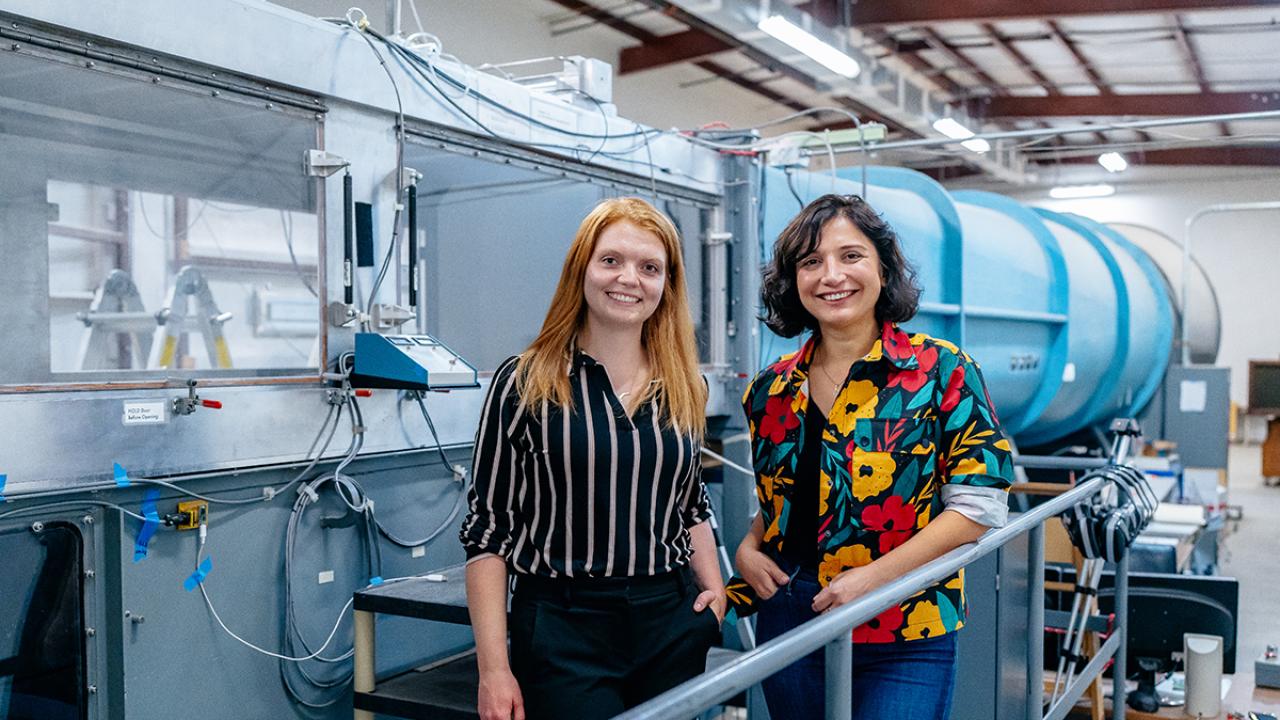 Assistant Professors Christina Harvey, left, and Camli Baydra in front of the Aeronautical Wind Tunnel