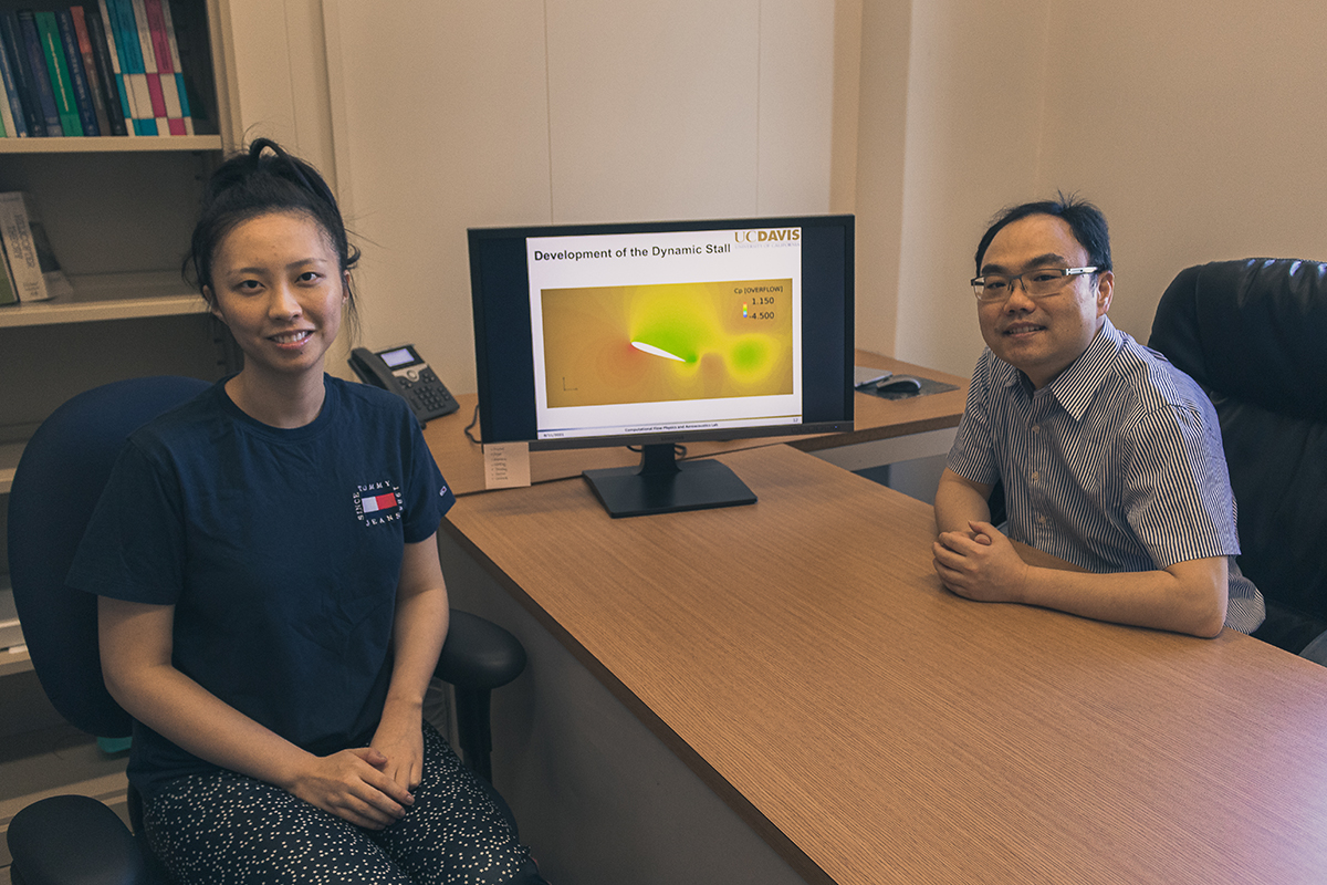 Jessica Shum and Seongkyu Lee sit at a table on opposite sides with a computer monitor between them