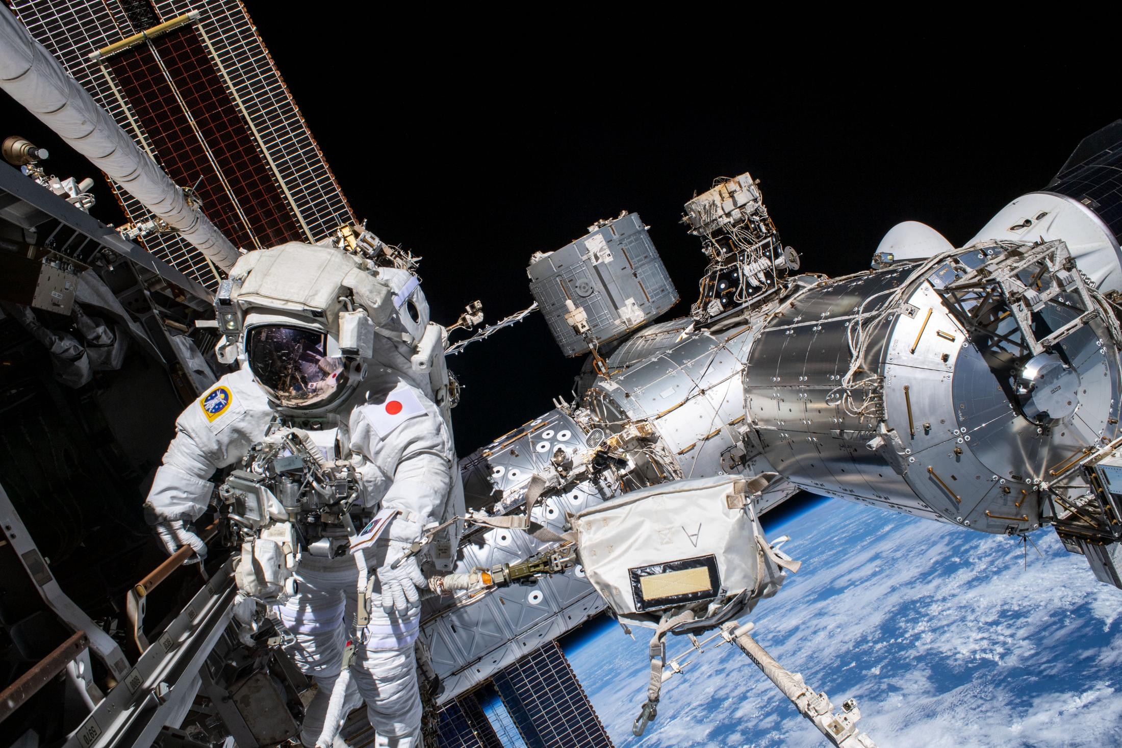 A group of NASA astronauts float in a space craft