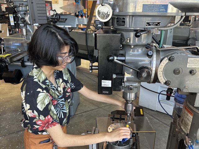 Person operates machinery in lab