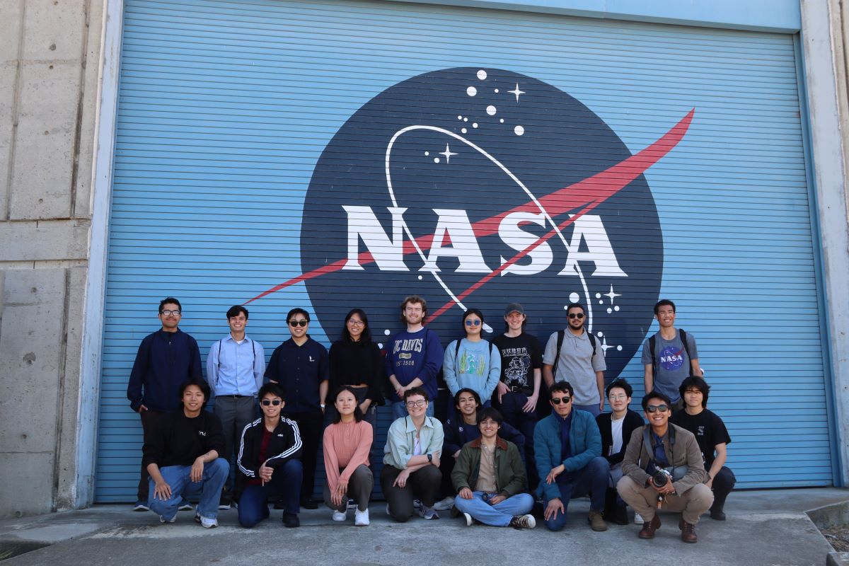 Group photo in front of NASA logo