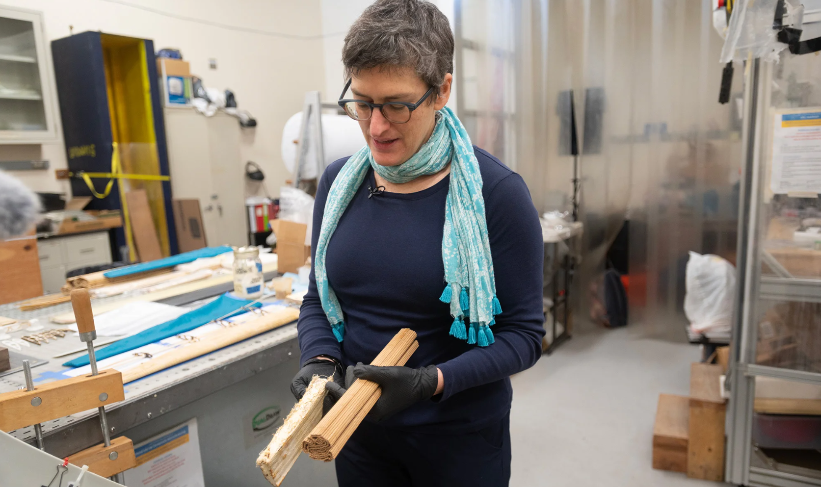 Woman holds rectangular materials in a lab