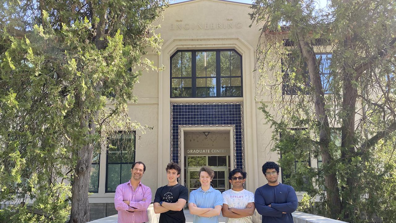 Five people stand outside of an engineering building on the UC Davis campus