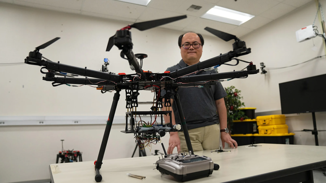Researcher Zhaodan Kong stands behind wildfire drone