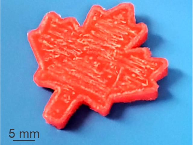 Reddish orange printed maple leaf on a blue background, 5mm large