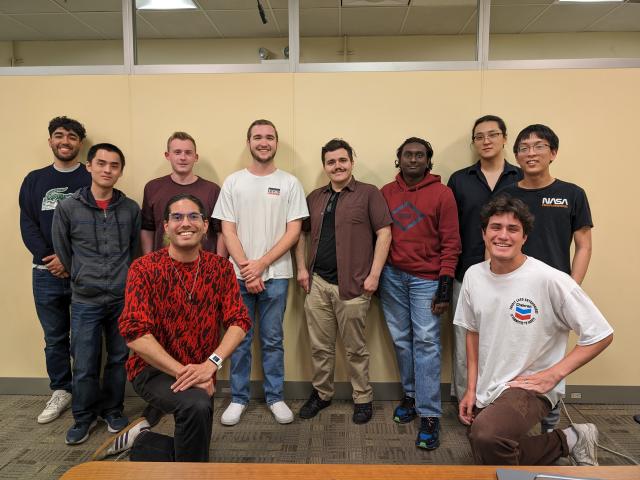 Large group of students pose for a photo indoors