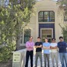 Five people stand outside of an engineering building on the UC Davis campus
